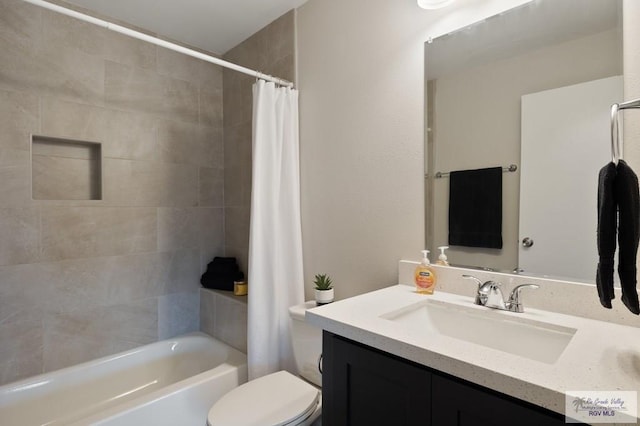 full bathroom featuring vanity, shower / bath combo, and toilet