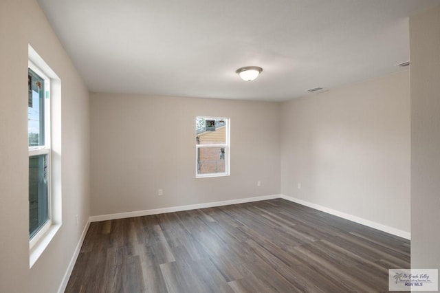 unfurnished room with dark hardwood / wood-style floors