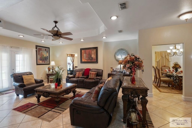 31660 Fm 1575, Los Fresnos, TX 78566 - living room featuring light tile patterned flooring, ceiling fan, a chandelier, a tray ceiling, and recessed lighting
