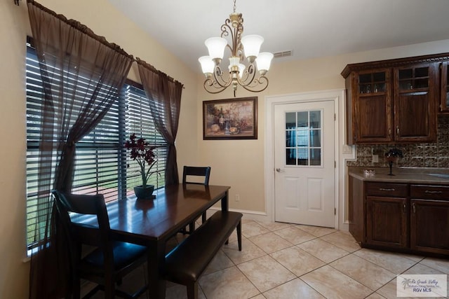 31660 Fm 1575, Los Fresnos, TX 78566 - dining space with a chandelier, healthy amount of natural light, light tile patterned flooring, and baseboards