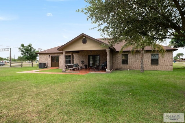31660 Fm 1575, Los Fresnos, TX 78566 - rear view of property with french doors, a patio area, central AC, and brick siding