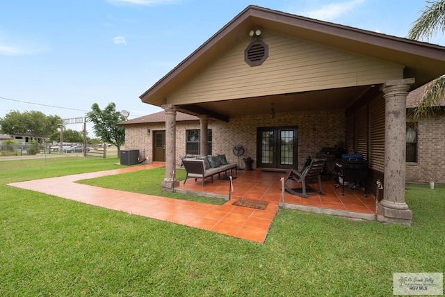 31660 Fm 1575, Los Fresnos, TX 78566 - rear view of property with french doors, a lawn, a patio area, brick siding, and central AC
