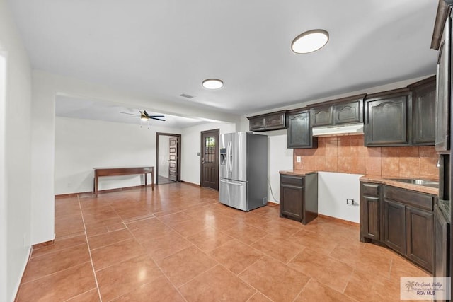 2307 Carlos Ave, Brownsville, TX 78526 - kitchen with tasteful backsplash, light countertops, a ceiling fan, stainless steel fridge, and under cabinet range hood