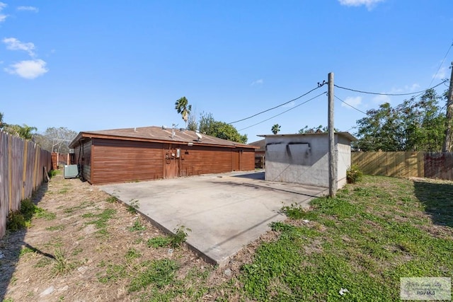 2307 Carlos Ave, Brownsville, TX 78526 - rear view of house featuring a fenced backyard, a patio, an outdoor structure, and a storage shed