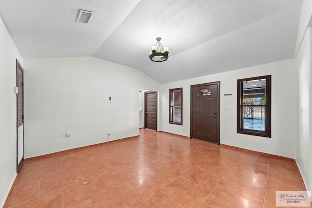 2307 Carlos Ave, Brownsville, TX 78526 - foyer entrance with lofted ceiling, visible vents, and an inviting chandelier