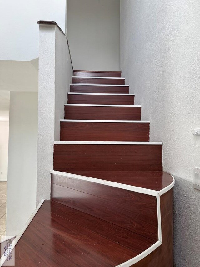 stairs featuring wood-type flooring