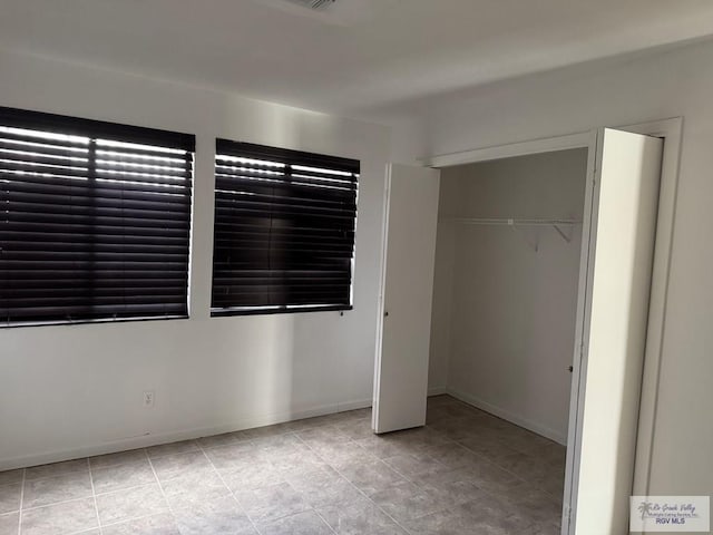 unfurnished bedroom with a closet