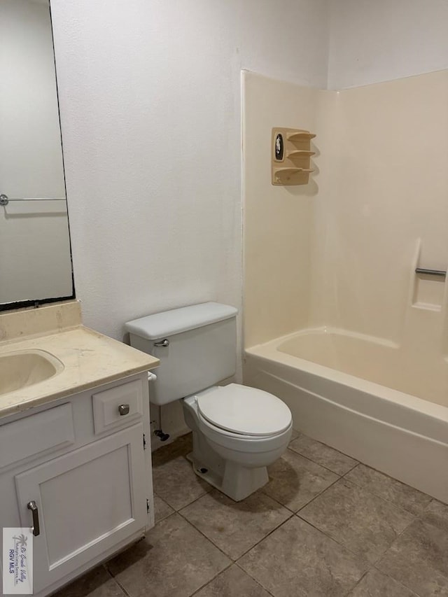 full bathroom featuring vanity, tile patterned flooring, bathing tub / shower combination, and toilet