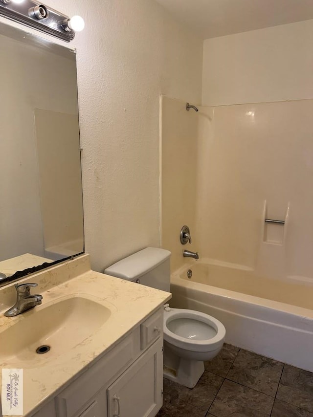 full bathroom featuring shower / washtub combination, vanity, tile patterned floors, and toilet