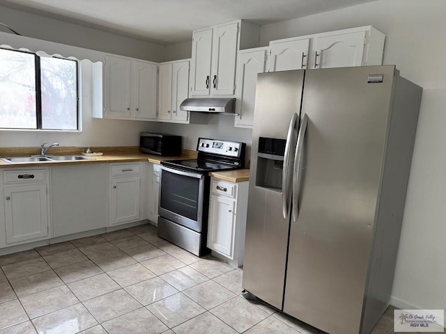 kitchen featuring light tile patterned floors, appliances with stainless steel finishes, sink, and white cabinets