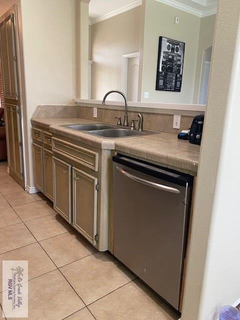 kitchen with stainless steel dishwasher, crown molding, sink, light tile patterned floors, and tile counters