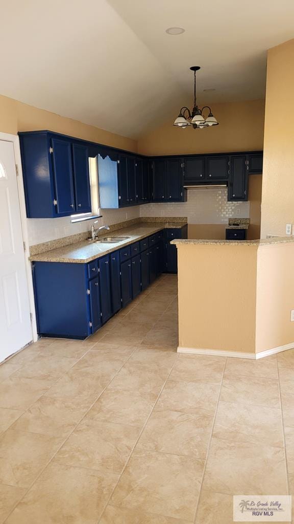 kitchen with blue cabinetry, decorative light fixtures, a chandelier, and vaulted ceiling