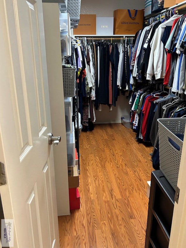 walk in closet featuring light hardwood / wood-style flooring