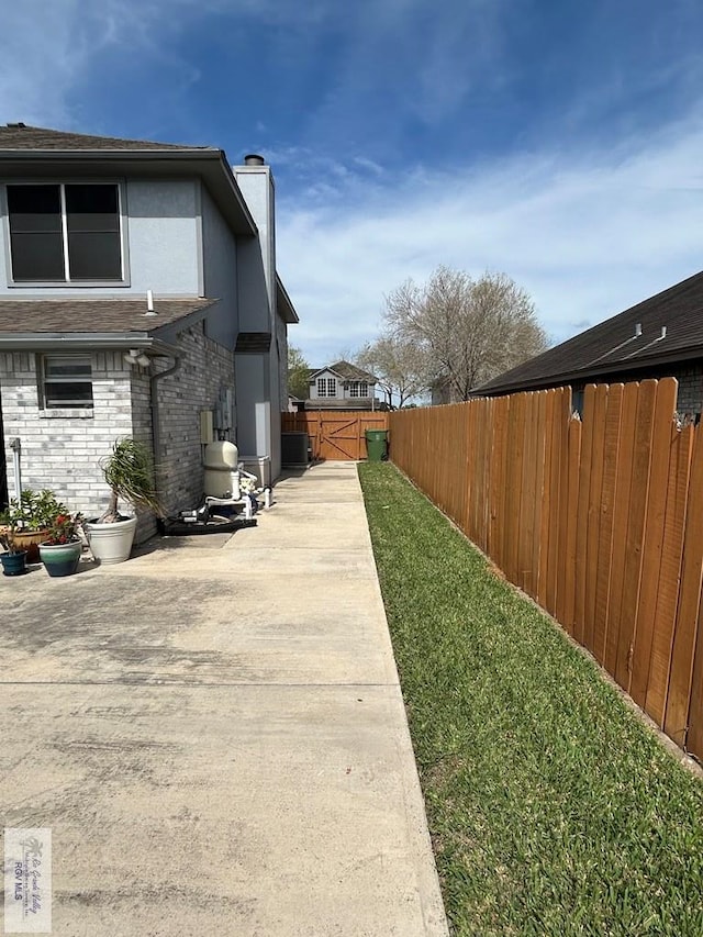 view of home's exterior featuring a yard and a patio area