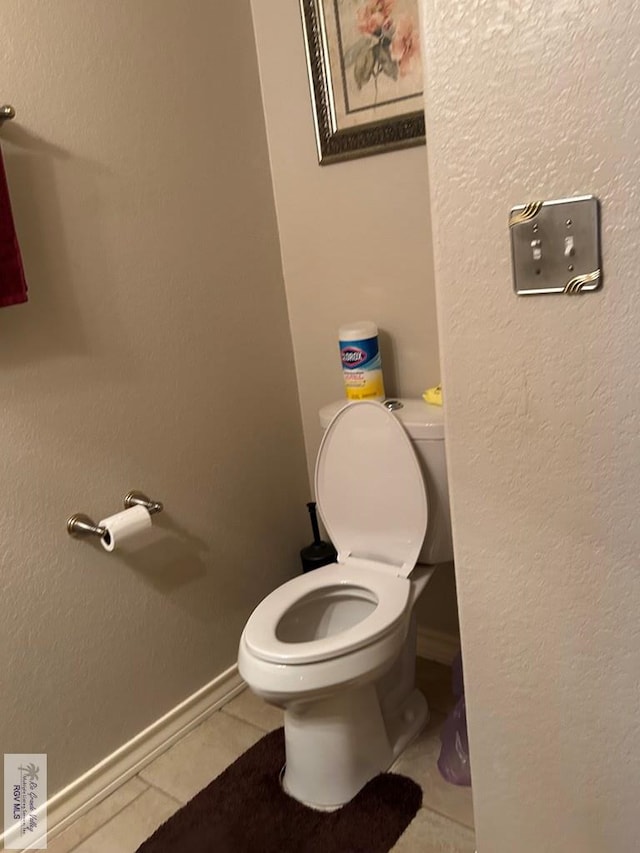 bathroom with tile patterned flooring and toilet