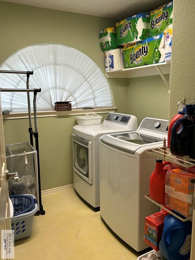 clothes washing area featuring independent washer and dryer