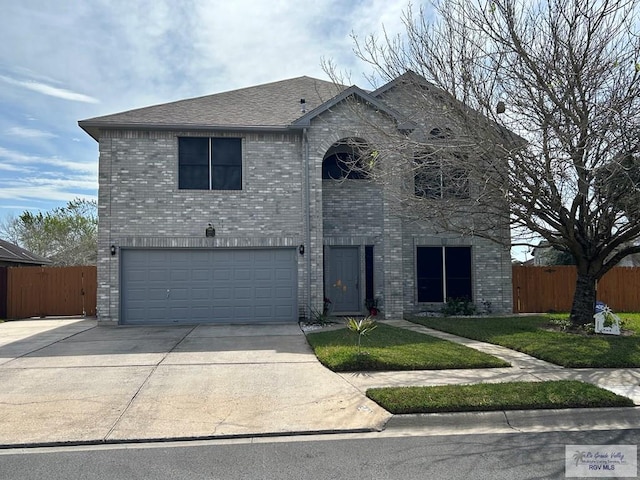 view of front of home featuring a garage and a front lawn