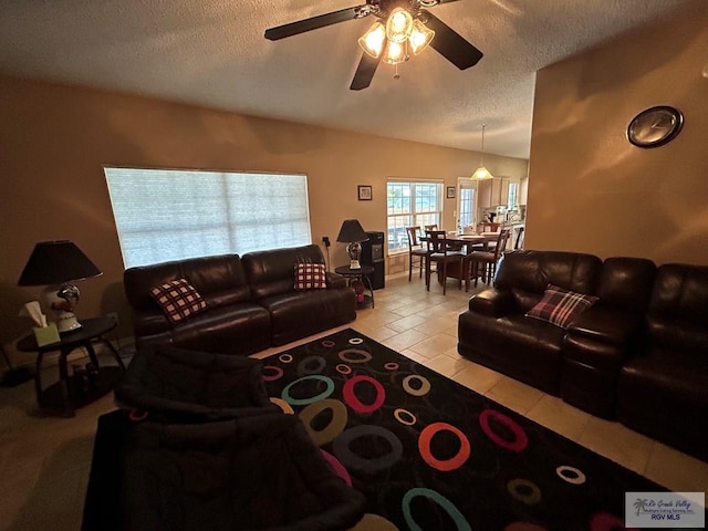 living room with light tile patterned floors, a textured ceiling, and ceiling fan