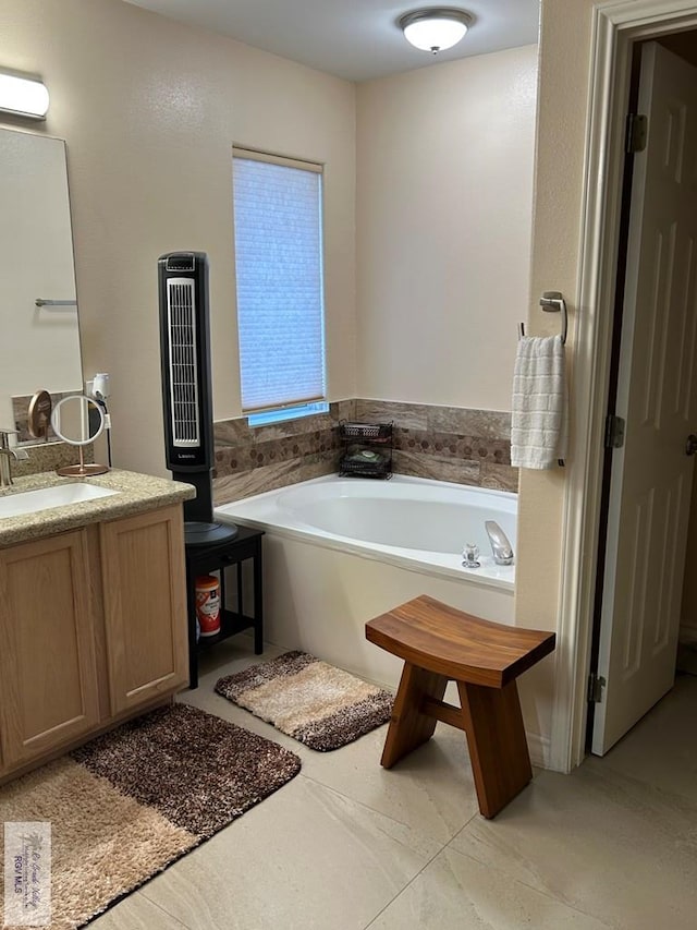 bathroom with vanity and a tub