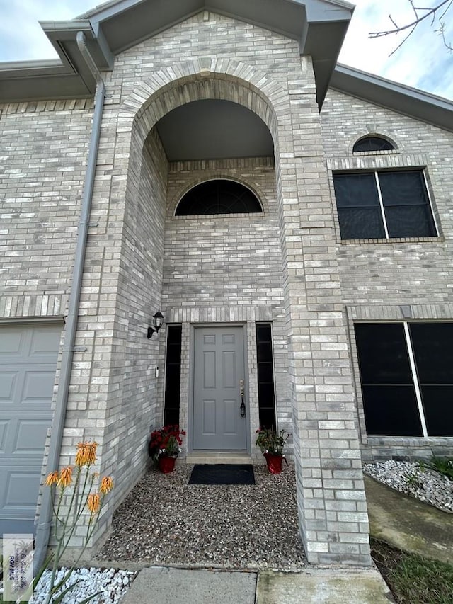 doorway to property with a garage