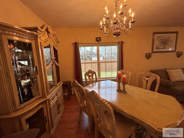 dining area featuring a notable chandelier and a textured ceiling