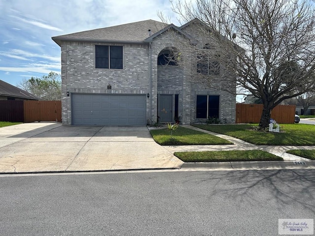 view of front facade with a garage and a front lawn