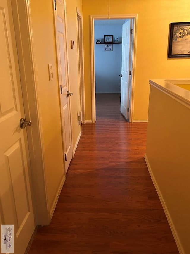 corridor with dark hardwood / wood-style floors