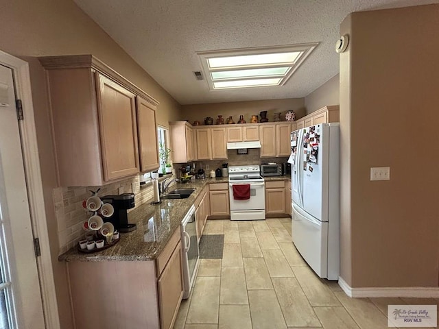 kitchen featuring tasteful backsplash, sink, light stone countertops, light brown cabinets, and white appliances