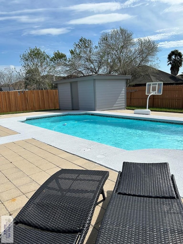 view of pool featuring an outbuilding