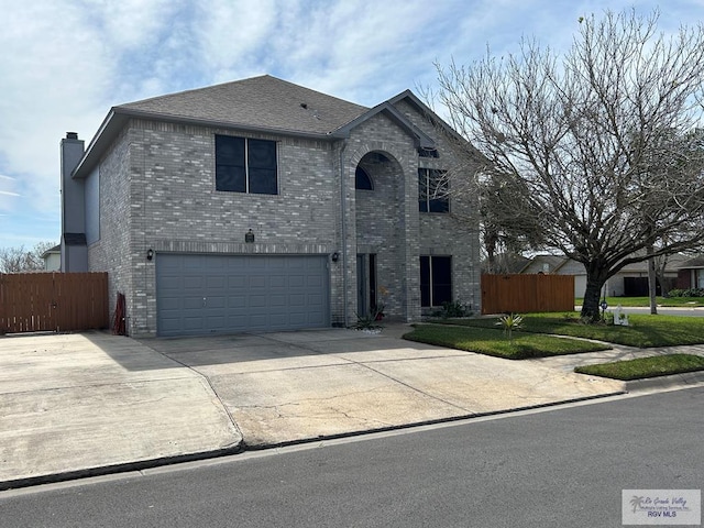 view of front of property with a garage and a front lawn