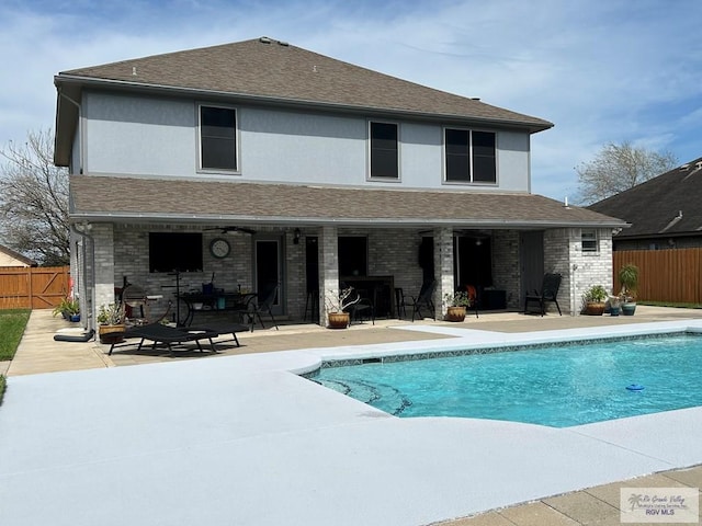 back of house featuring a fenced in pool and a patio area