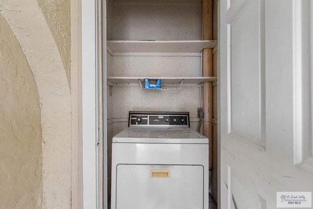 clothes washing area with washer / dryer