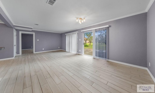 empty room featuring light hardwood / wood-style floors, ornamental molding, and a chandelier