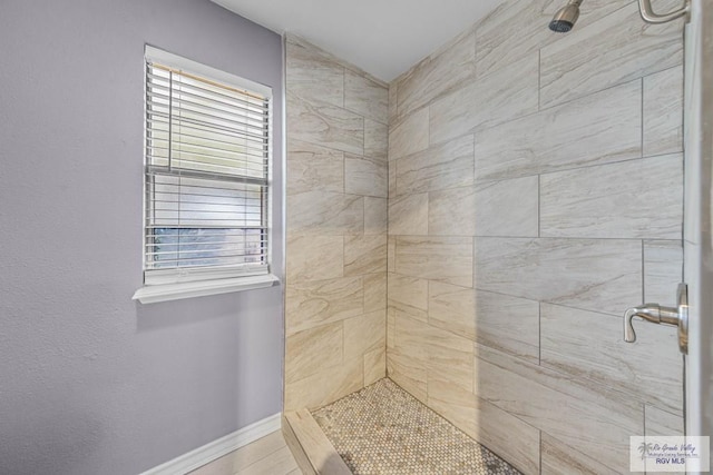 bathroom with tiled shower