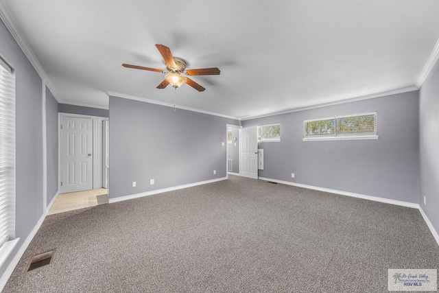 carpeted empty room featuring ceiling fan and crown molding