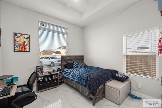 122 Heron Dr, Los Fresnos, TX 78566 - bedroom with marble finish flooring, an office area, ceiling fan, and a tray ceiling