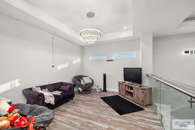 122 Heron Dr, Los Fresnos, TX 78566 - living room featuring a tray ceiling, light wood-type flooring, and recessed lighting