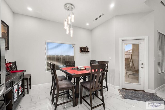 122 Heron Dr, Los Fresnos, TX 78566 - dining space featuring light marble finish floors and recessed lighting