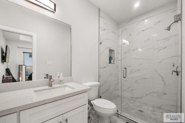 122 Heron Dr, Los Fresnos, TX 78566 - bathroom featuring a marble finish shower, vanity, and marble finish flooring