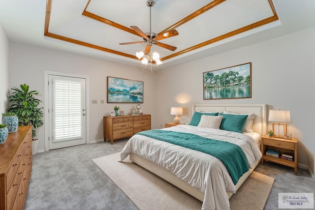 carpeted bedroom with a raised ceiling, access to exterior, and ceiling fan