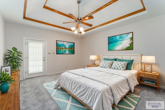 bedroom with ceiling fan, access to exterior, a raised ceiling, and carpet