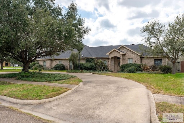 ranch-style home featuring a front yard