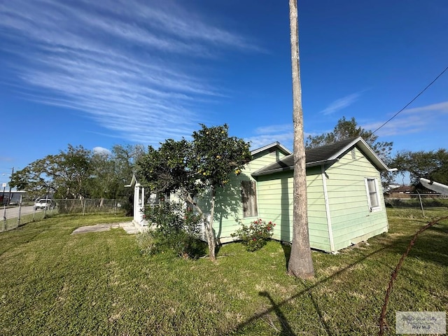 view of home's exterior with a lawn