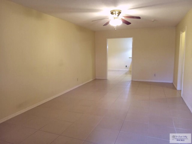 spare room featuring ceiling fan and light tile patterned floors