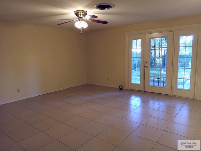 unfurnished room with ceiling fan and light tile patterned flooring