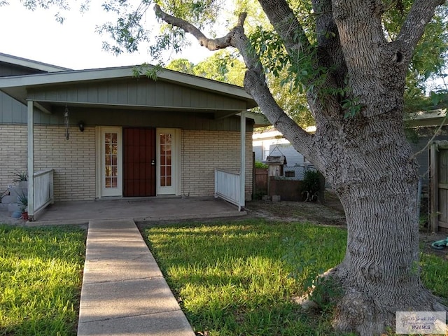 doorway to property with a yard