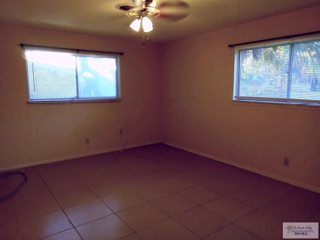 spare room with light tile patterned floors and ceiling fan