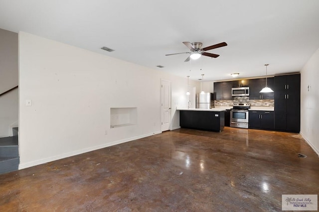 kitchen with ceiling fan, kitchen peninsula, decorative light fixtures, decorative backsplash, and appliances with stainless steel finishes