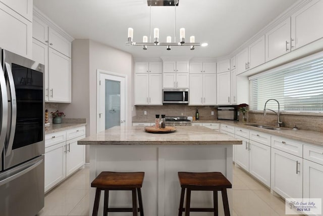 9470 Cajun, Los Fresnos, TX 78566 - kitchen with a sink, white cabinetry, light tile patterned floors, and appliances with stainless steel finishes