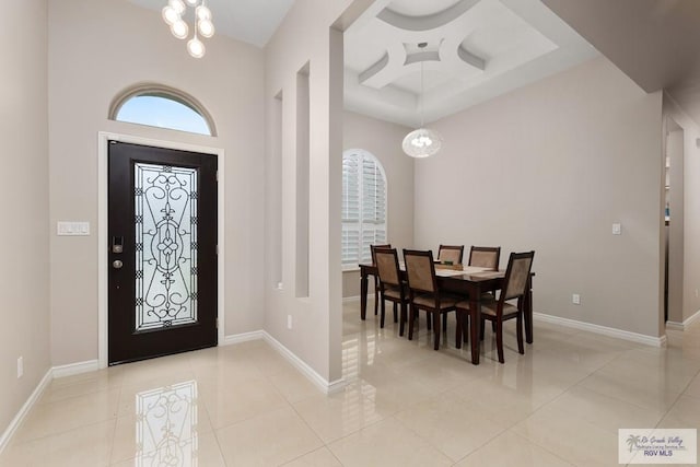 9470 Cajun, Los Fresnos, TX 78566 - foyer with coffered ceiling, an inviting chandelier, a wealth of natural light, and light tile patterned floors